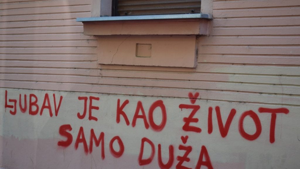 Red graffiti on a building wall
